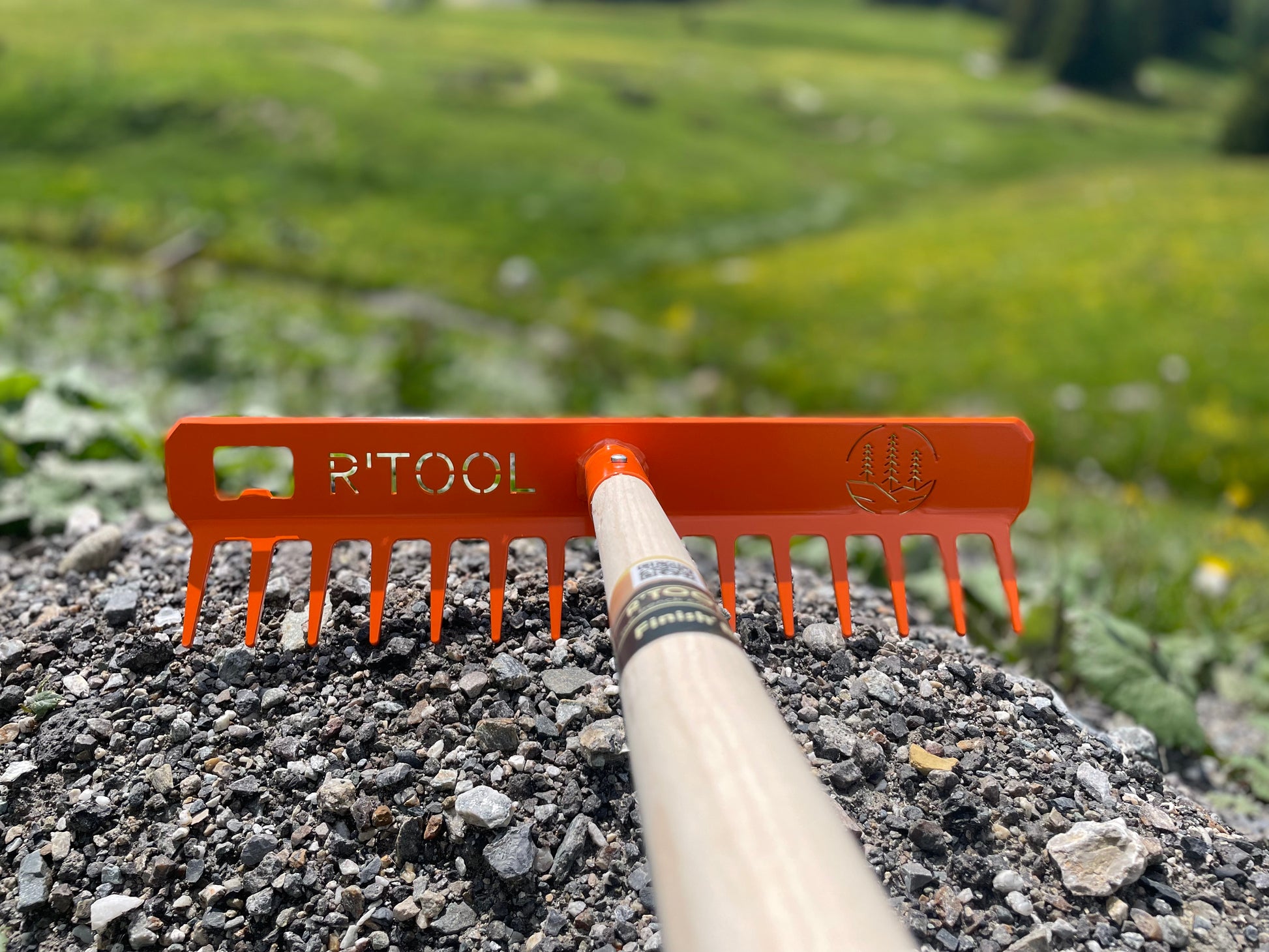 R'TOOL Finish'R trail building rake with wooden handle on mountain trail